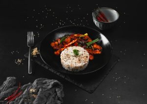 Delicious Asian dish with rice and vegetables on a dark backdrop.